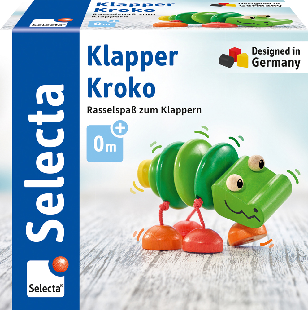 Verpackung mit einem „Selecta Klapper Kroko Holz Greifling“, einem grünen Krokodil-Babyspielzeug mit dem Aufdruck „Designed in Germany“.