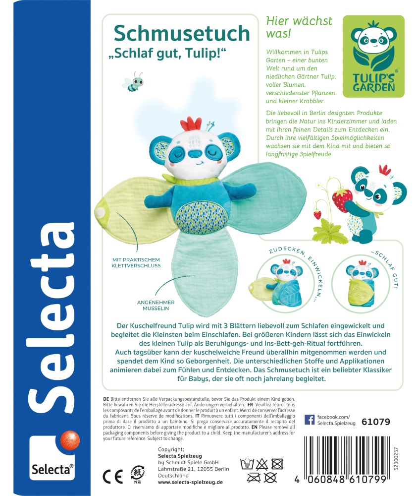 schmusetuch_09.2023_print Ein blau-grünes Plüsch-Schmusetuch mit blattförmigen Flügeln und einem lächelnden Gesicht, abgebildet auf einer weißen Produktverpackung.