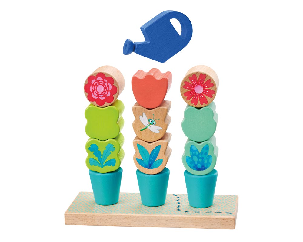 Blaue Gießkanne gießt über die Bausteine des Steckspiels von Tulips Garden.